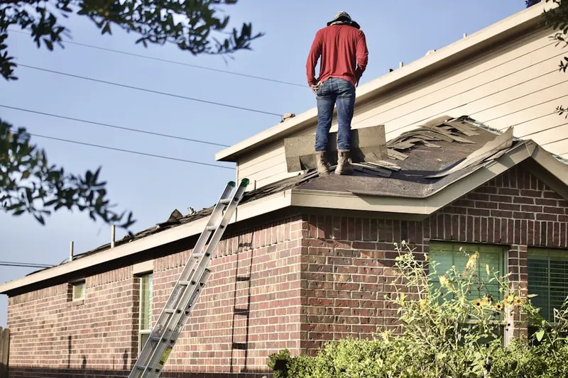 Professional roofer working on a residential roof in East Long Branch
